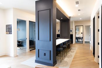 A modern kitchen with a tall dark blue cabinet and a white countertop.